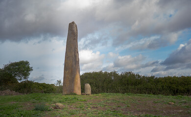 Menhir megalith stone in Sardinia Sardegna Italy big megalith stone standing in field archeological...