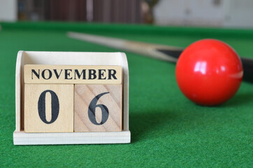 November 6, number cube with balls on snooker table, sport background.