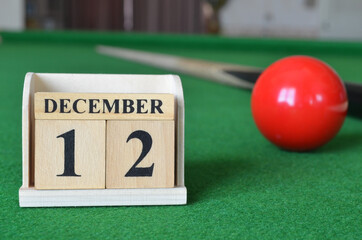 December 12, number cube with balls on snooker table, sport background.