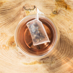 Glas of hot tea with sugar on wooden surface