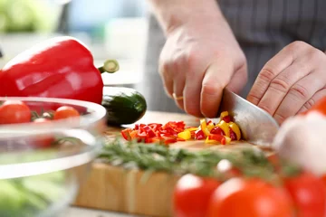 Fotobehang Culinary Chef Chopped Chili Pepper Small Slices. Man Cutting Ingredients by Sharp Knife on Wooden Board. Fresh and Healthy Food. Colorful and Delicious Dieting Salad Recipe Horizontal Photography © H_Ko
