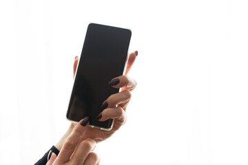 Mobile phone with a black screen on a white isolated background.
