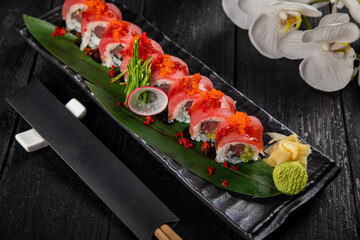 Japanese traditional rolls with tuna, caviar, on a dark table
