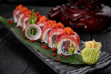 Japanese traditional rolls with tuna, caviar, on a dark table
