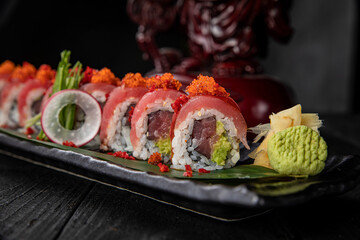 Japanese traditional rolls with tuna, caviar, on a dark table
