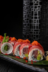 Japanese traditional rolls with tuna, caviar, on a dark table
