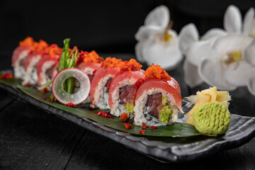 Japanese traditional rolls with tuna, caviar, on a dark table
