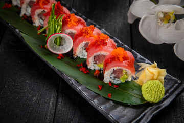 Japanese traditional rolls with tuna, caviar, on a dark table
