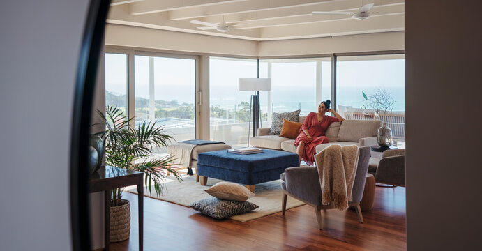 Woman relaxing on sofa in home showcase interior living room