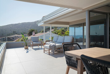 Dining table and sofa on sunny home showcase patio