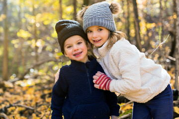 cute caucasian kids on fall season outdoors