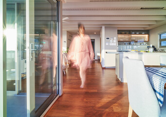 Blurred woman walking in luxury home showcase interior