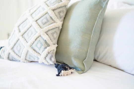 Close Up Decorative Pillow With Tassel On Bed