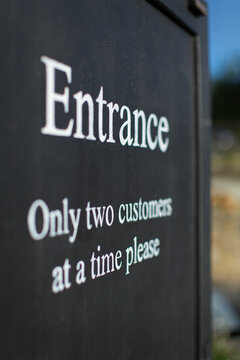 Social distancing sign at shop entrance