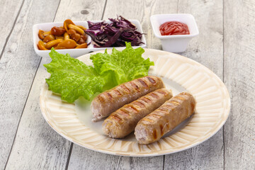 Grilled sausages served mushrooms and cabbage