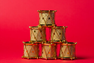 toy drums gold color on red background. Christmas decorations on a red background. Christmas decorations. Holiday decorations. Christmas concept
