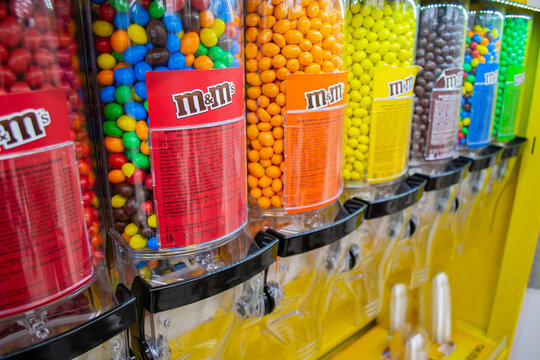Moscow, Russia, November 2019: Close up of M&M Candies at Candy Dispenser Machines in the supermarket. Colorful button-shaped chocolates in bulk