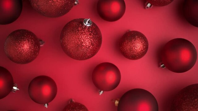 Merry Christmas. flat lay with Christmas balls on red background. This video was shot in PRORes 422 codec.
