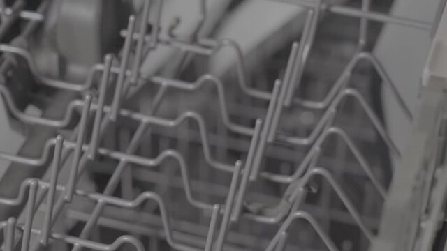 Panning empty top of modern residential dishwasher