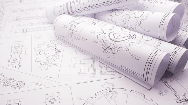 paper engineering drawings of industrial parts and mechanisms