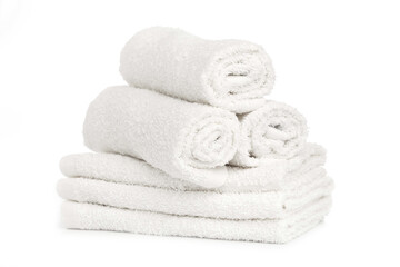 Fototapeta na wymiar several white clean towels rolled up on a white background