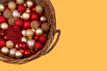 basket with Christmas decorations on a yellow background
