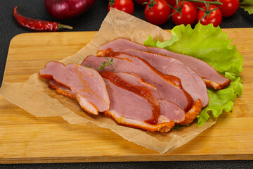 Sliced smoked duck breast served salad