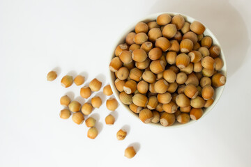 ripe hazelnuts in a peel on a white background	