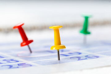Thumbtack in calendar concept for busy, appointments and meeting reminders