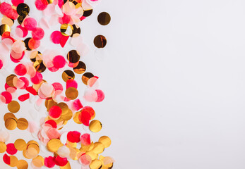 Colorful confetti on white background with copy space