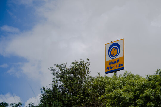 Signage of bharat petroleum standing from the middle of trees showing a fuel pump from one of the largest public sector undertaking in the petroleum space