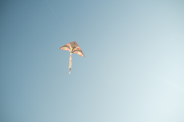 Flying kite on the blue sky. Copy space.
