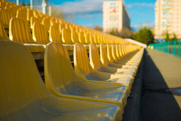 Fototapeta premium Empty sits on a tribune on a stadium due to virus.