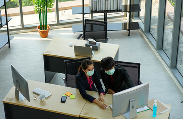business woman worked in the office wearing surgical face mask to prevent from virus pandemic with...