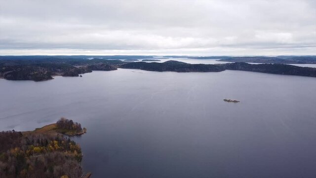 Flying over the lakes and fjords. small islands on lake water.