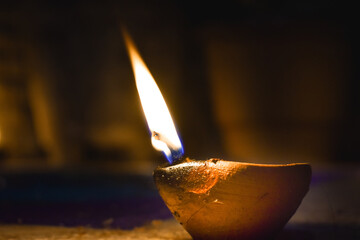 Happy Diwali - Close up of lit Diya lamps on floor during Indian festival Diwali