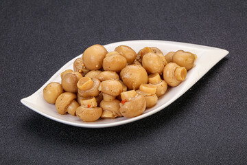 Pickled champignons in the bowl