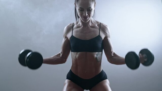 Professional female bodybuilder training muscles