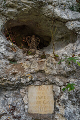 Holy stone statue in the Brother Klaus grotto at Beuron Monastery in the Danube Valley in autumn