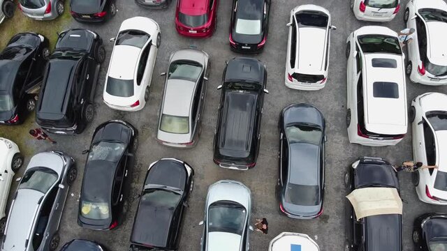 AERIAL: Drone Takes off Above the Packed Parking Zone with Cars which Wait in Queue to be Transported by Ferry from The Koh Chang Island to Mainland of Trat, Thailand, Asia.