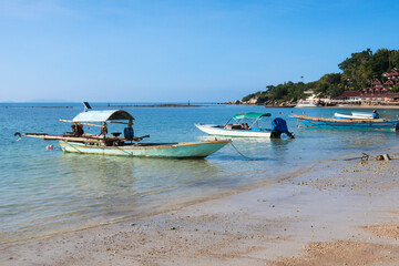 Fototapeta na wymiar Fishing boats long tail moored at secret beach in Koh Phangan, Thailand, Asia