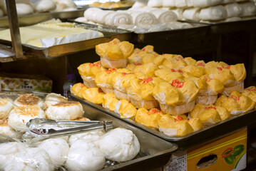 Chinese steamed buns and pastries for sale at market in Hong...