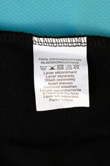 White label on clothing indicating the percentage of material content in the fabric. The...