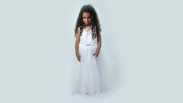 Cute little girl wearing white princess dress crying