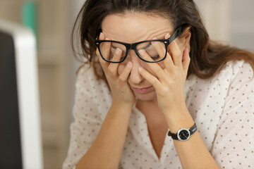 overworked businesswoman suffering from headache