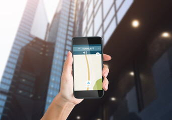 Hand Holding Phone With Navigation App Walking In Urban Area
