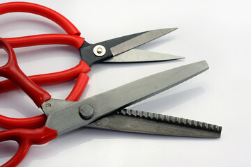 Tailoring scissors zigzag on a white background. Serrated fabric scissors. Tools for cutting heavy...