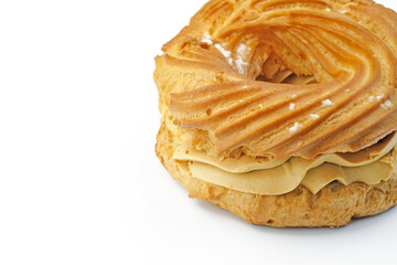 Eclair with butter cream on a white background. Round quiche with cream close-up. Dessert stuffed with condensed milk.