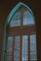 Window with wooden slotted shutters
