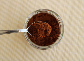 fresh ground coffee in the spoon, top view